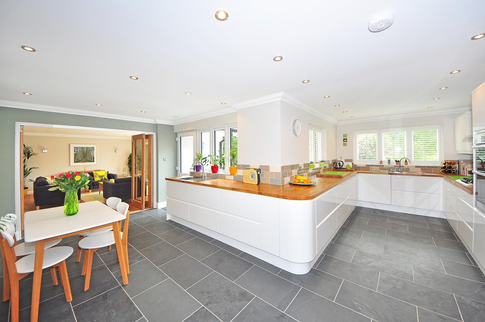 Open kitchen with curved island and dining table