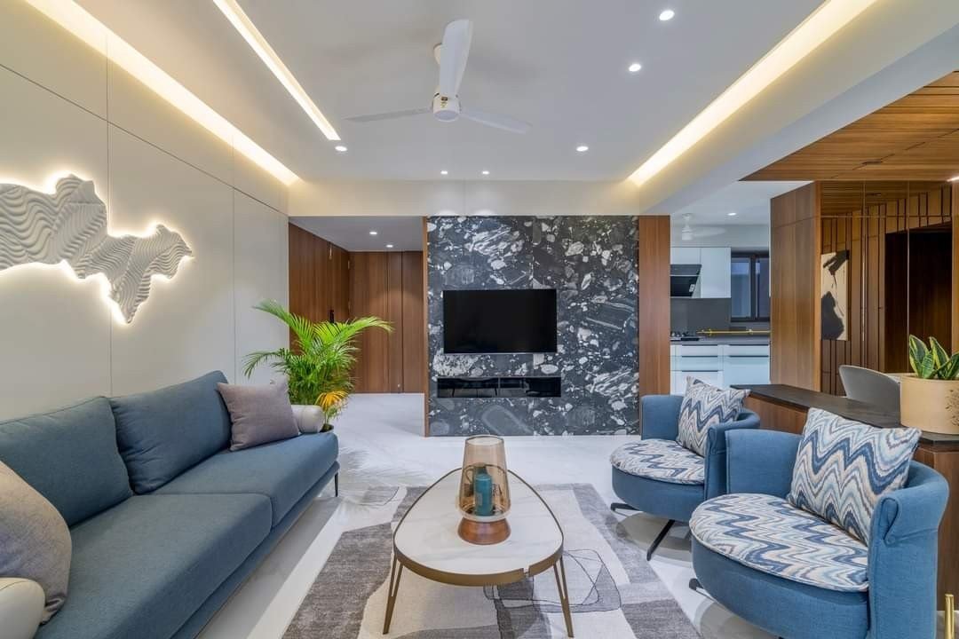 Living room with blue seating and a stone feature wall