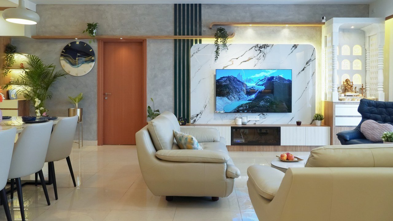 Living room with marble TV wall and cream sofas